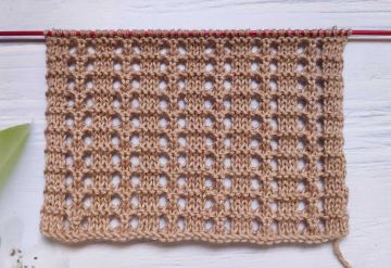 Point oeillet simple au tricot